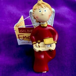 Gilde angel figurines and ornaments. Item no: 28004. Kneeling boy holding train.
